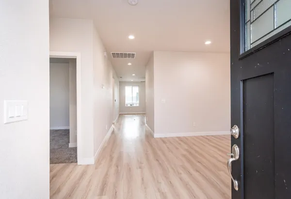 a view of a hallway with wooden floor