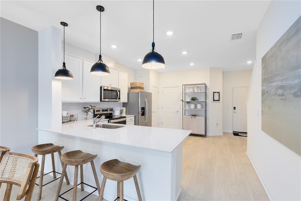 4445 Jetty Lane Palm Bay, FL 32905 - Photo 11 of 32 a kitchen with stainless steel appliances granite countertop a sink a stove a refrigerator and island