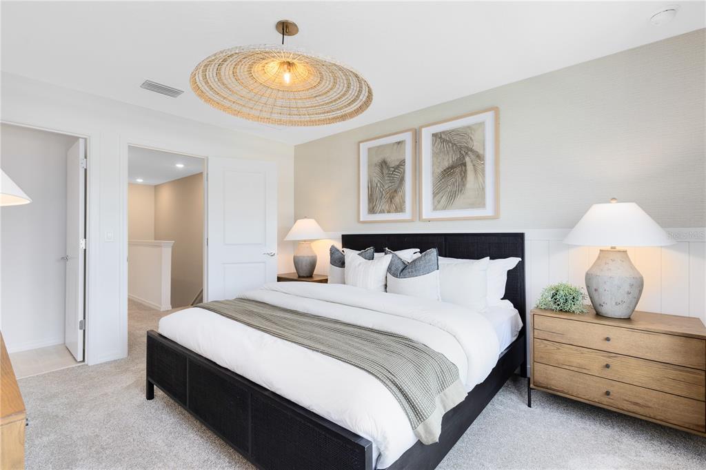 4445 Jetty Lane Palm Bay, FL 32905 - Photo 19 of 32 a bedroom with a bed and a chandelier