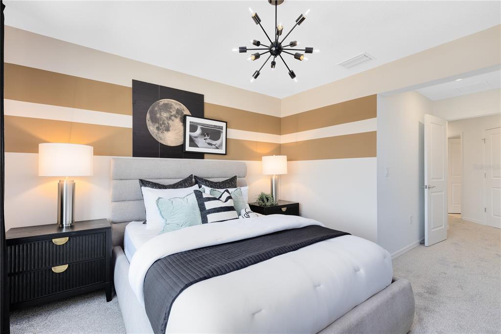 4445 Jetty Lane Palm Bay, FL 32905 - Photo 26 of 32 a bedroom with a bed and a lamp on table