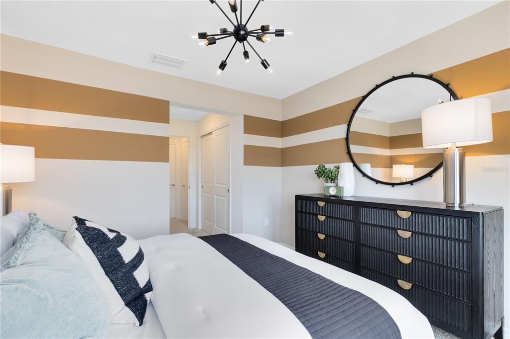 4445 Jetty Lane Palm Bay, FL 32905 - Photo 27 of 32 a bedroom with a bed and a mirror on the dresser