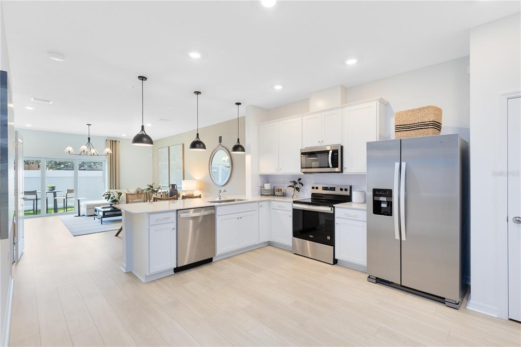 4445 Jetty Lane Palm Bay, FL 32905 - Photo 5 of 32 a large kitchen with granite countertop a large counter top stainless steel appliances and cabinets