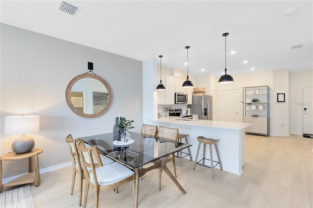 4445 Jetty Lane Palm Bay, FL 32905 - Photo 8 of 32 a dining room with stainless steel appliances kitchen island a table and chairs