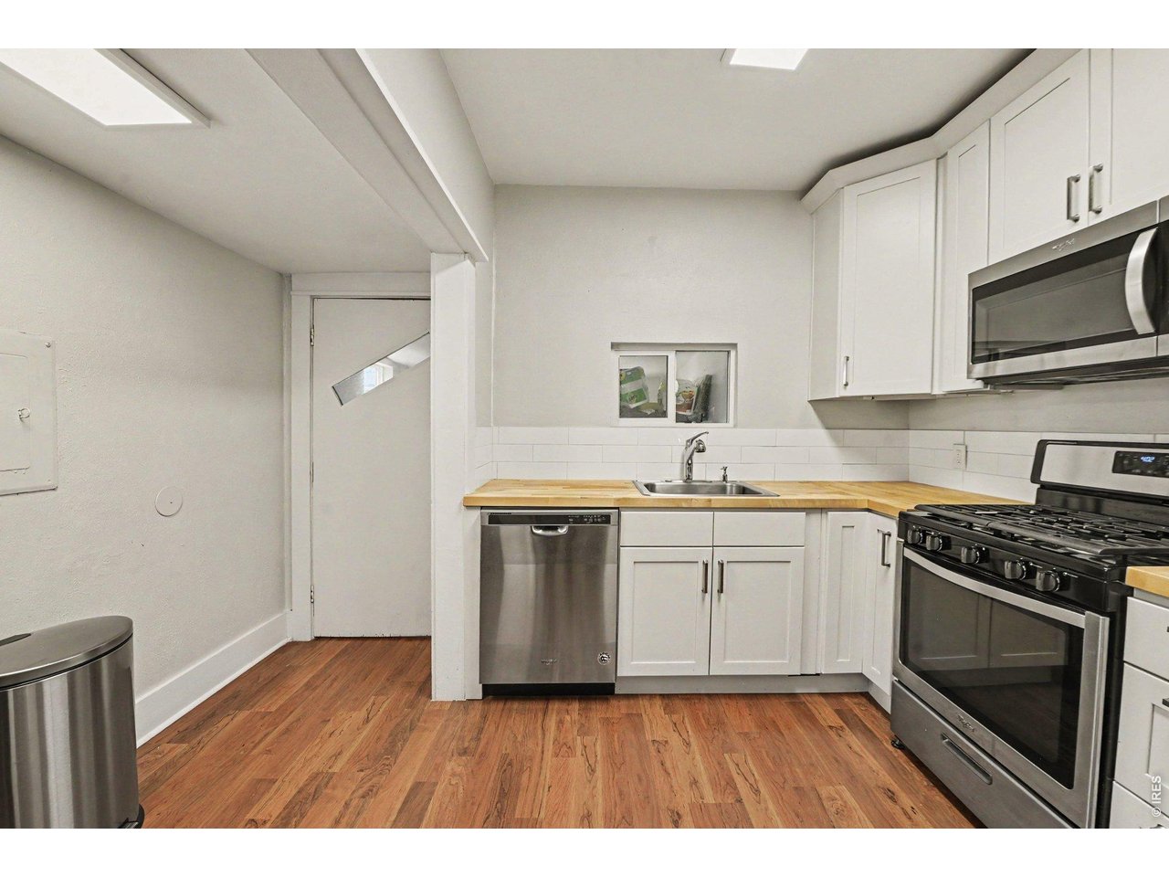 427 9th Street Greeley, CO 80631 - Photo 13 of 22 a kitchen with a sink stove and microwave