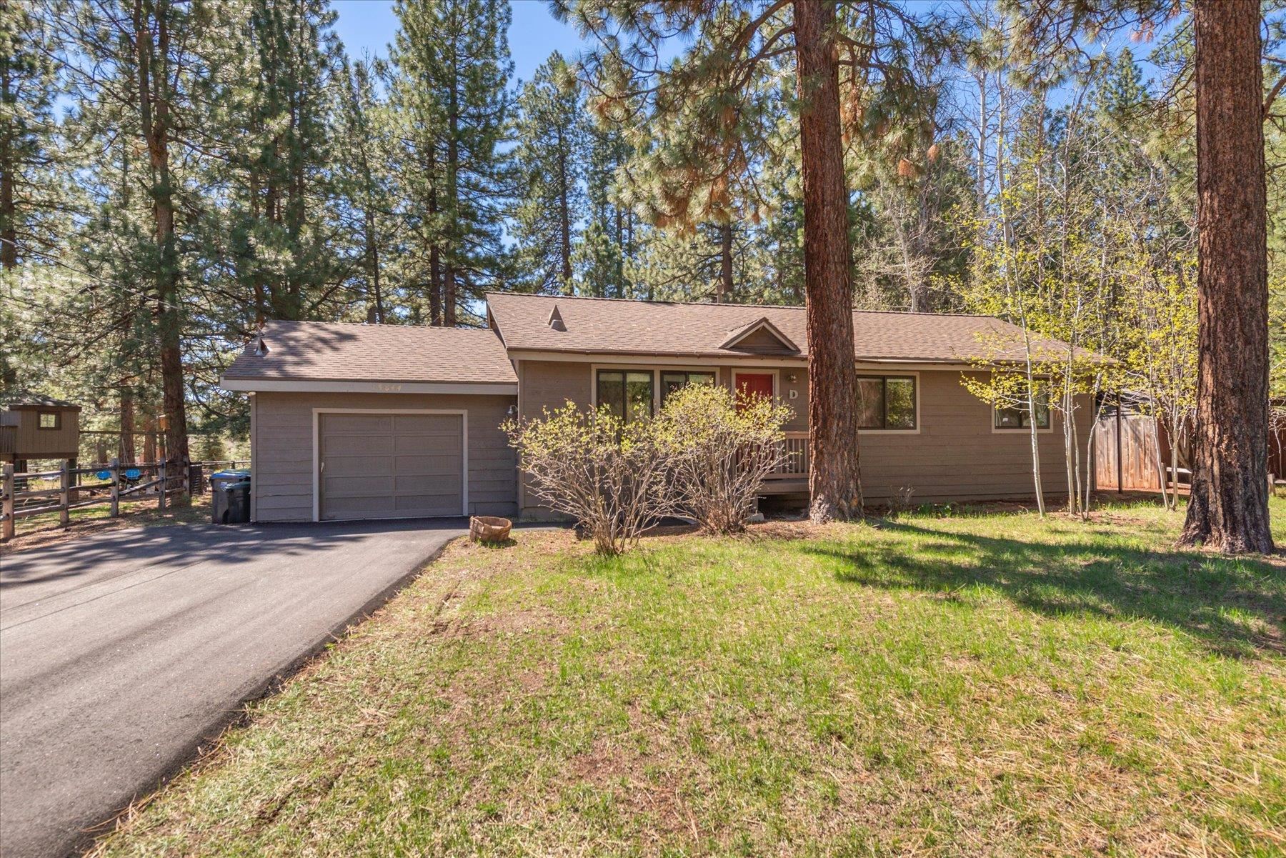 a view of a house with a yard and garage