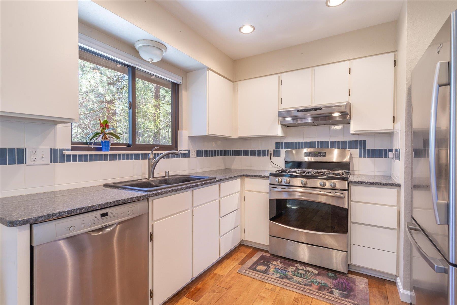 15844 Archery View Truckee, CA 96161 - Photo 13 of 26 a kitchen with stainless steel appliances granite countertop a sink stove and refrigerator