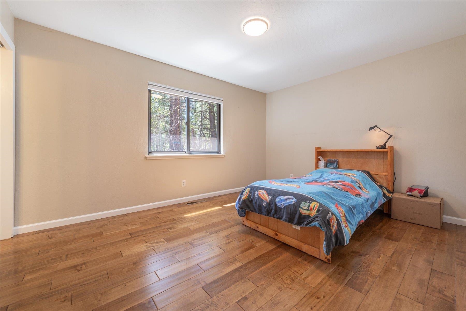 15844 Archery View Truckee, CA 96161 - Photo 20 of 26 a bedroom with a bed and wooden floor