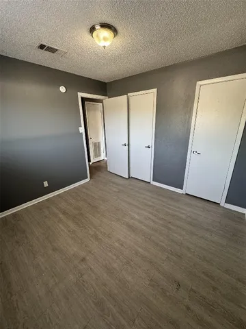 a bathroom with a granite countertop sink toilet and a mirror