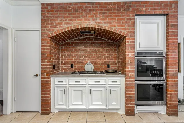 a kitchen with granite countertop a stove top oven