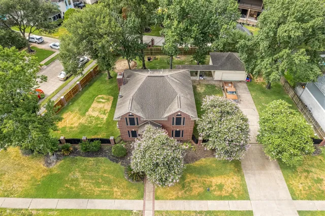 an aerial view of a house with yard swimming pool and outdoor seating