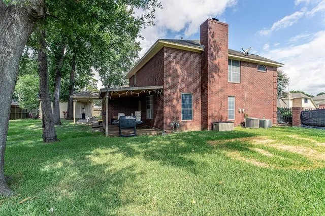 a view of a house with a yard and sitting area