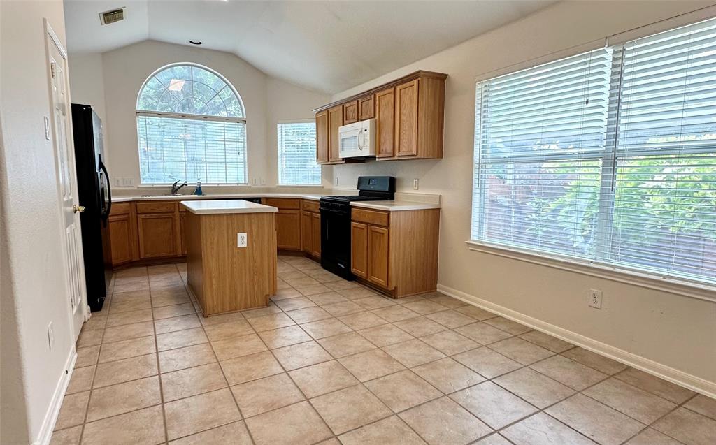13508 Oregon Flat Trail Austin, TX 78727 - Photo 3 of 16 a kitchen with stainless steel appliances granite countertop a stove a sink and a refrigerator
