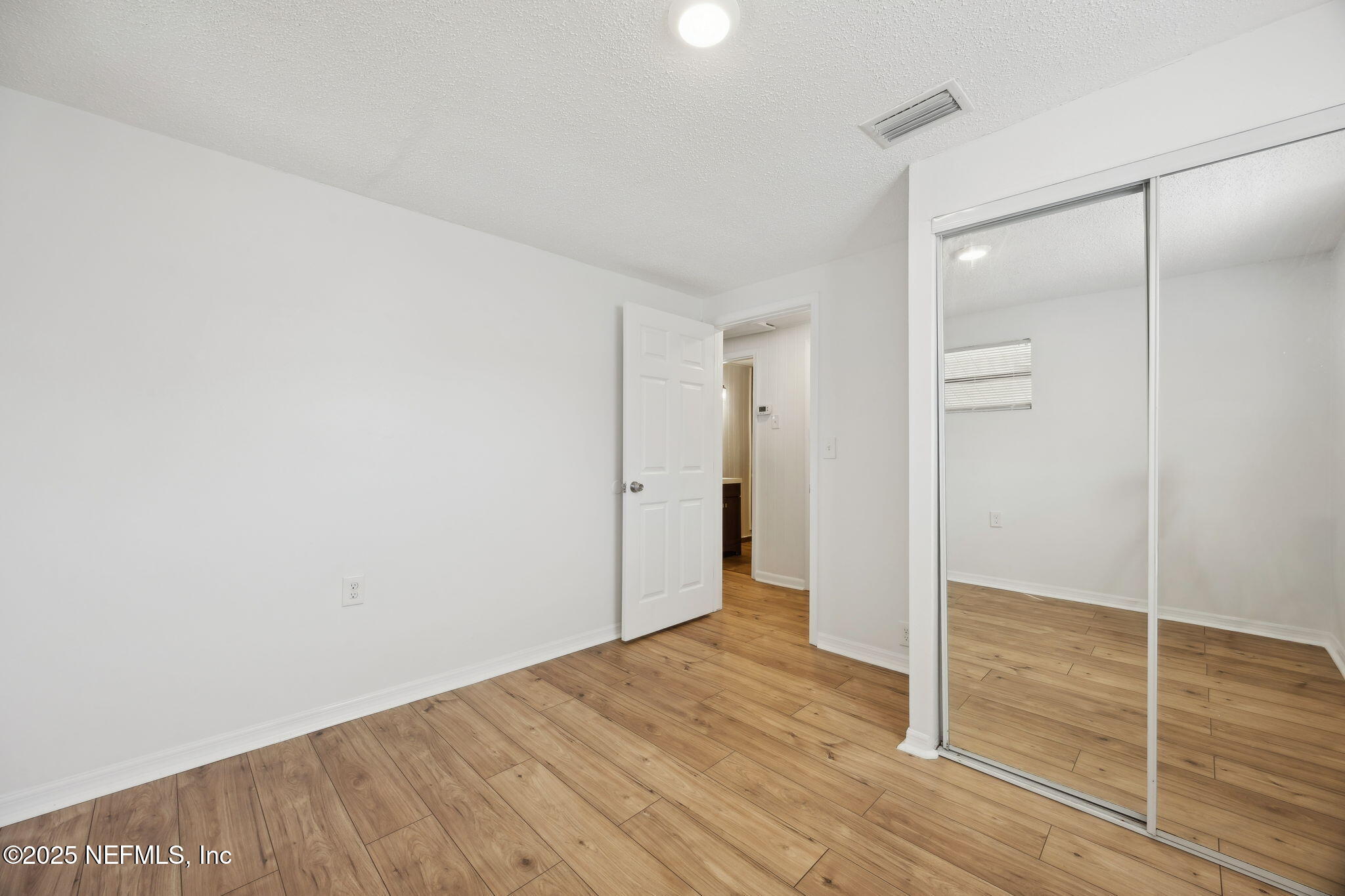 44186 Lee Drive Callahan, FL 32011 - Photo 12 of 28 a view of an empty room with wooden floor