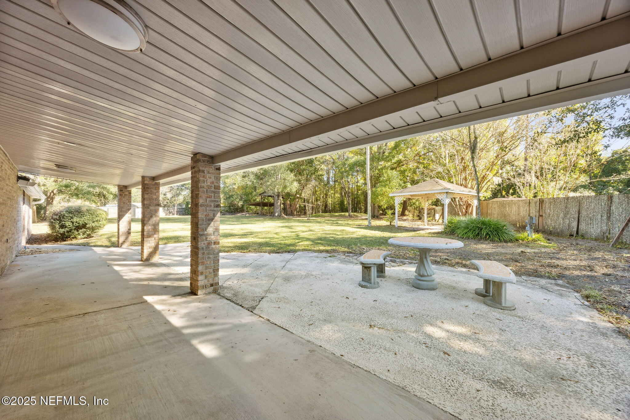 44186 Lee Drive Callahan, FL 32011 - Photo 20 of 28 a view of a patio with table and chairs next to a yard