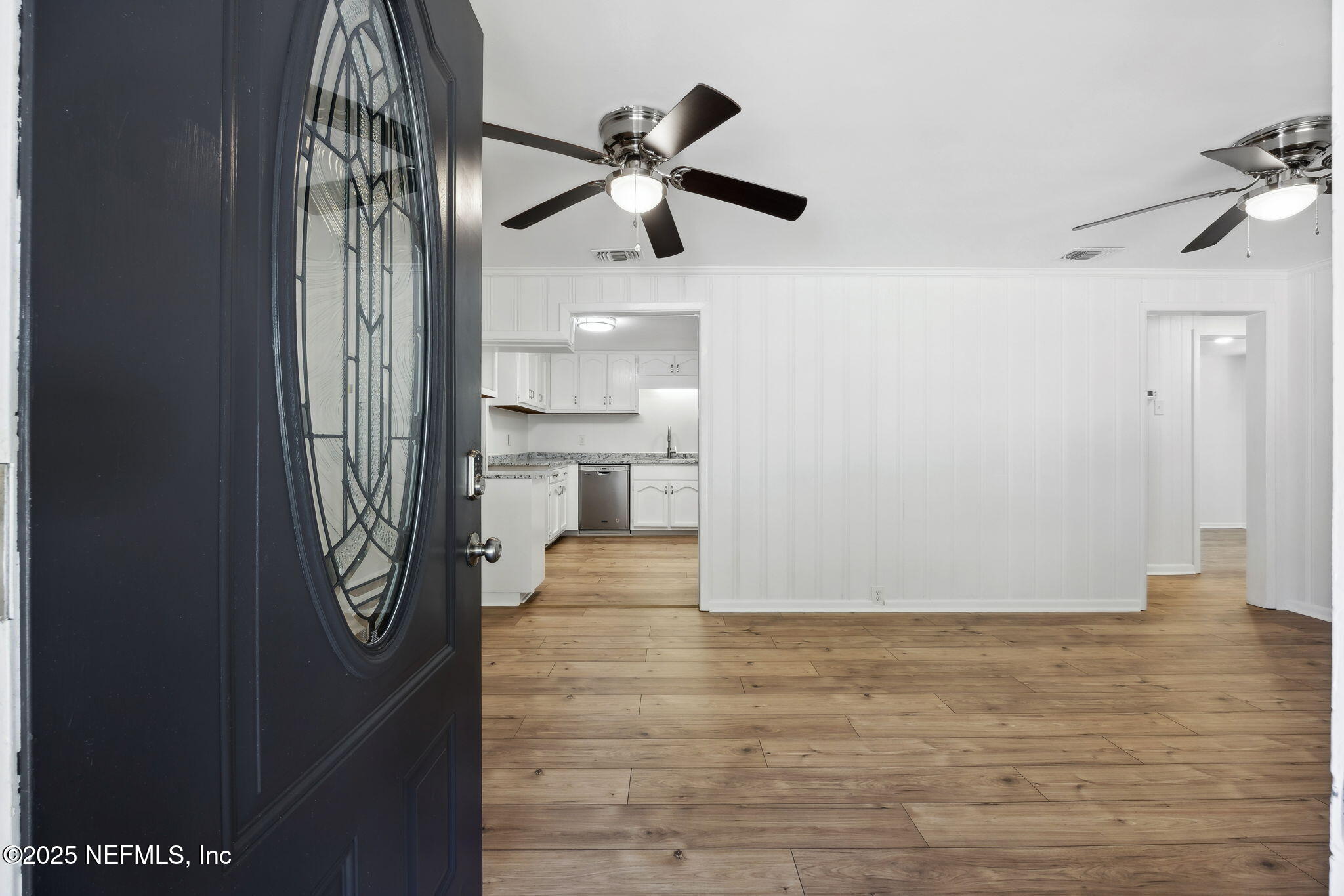 44186 Lee Drive Callahan, FL 32011 - Photo 3 of 28 a view of empty room with wooden floor and fan