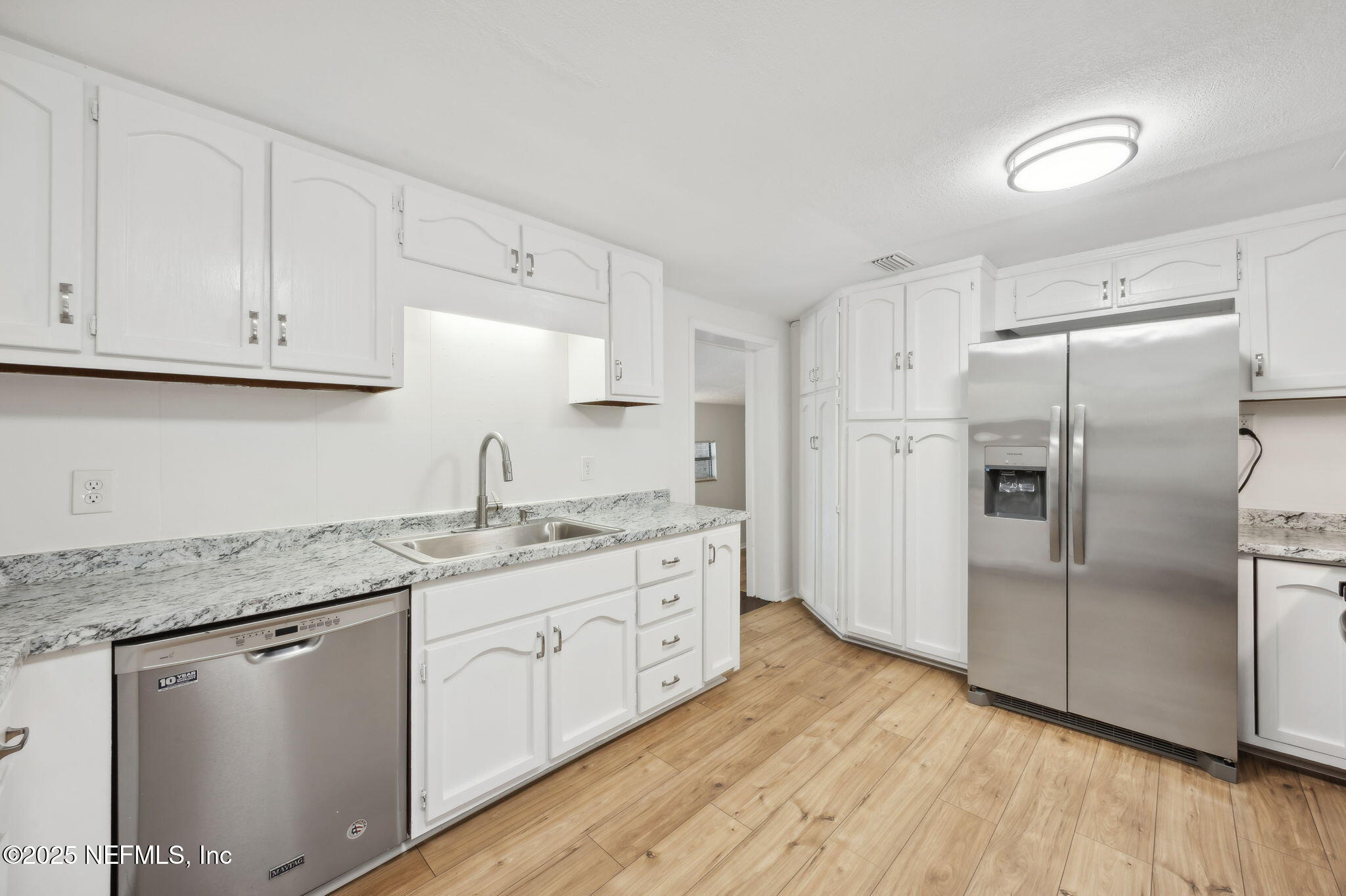 44186 Lee Drive Callahan, FL 32011 - Photo 6 of 28 a kitchen with stainless steel appliances granite countertop a refrigerator sink and cabinets