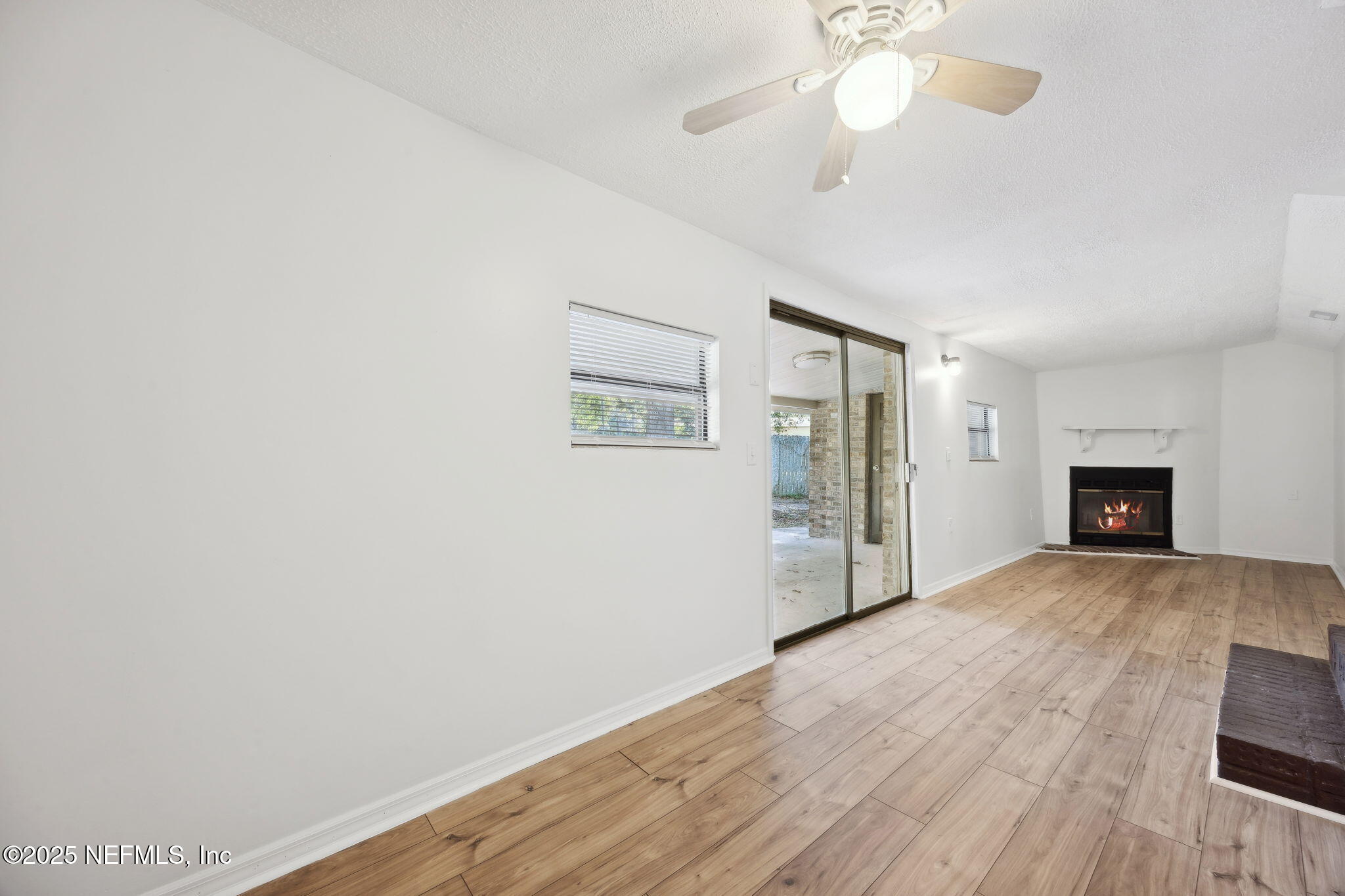44186 Lee Drive Callahan, FL 32011 - Photo 7 of 28 a view of an empty room with wooden floor and a window