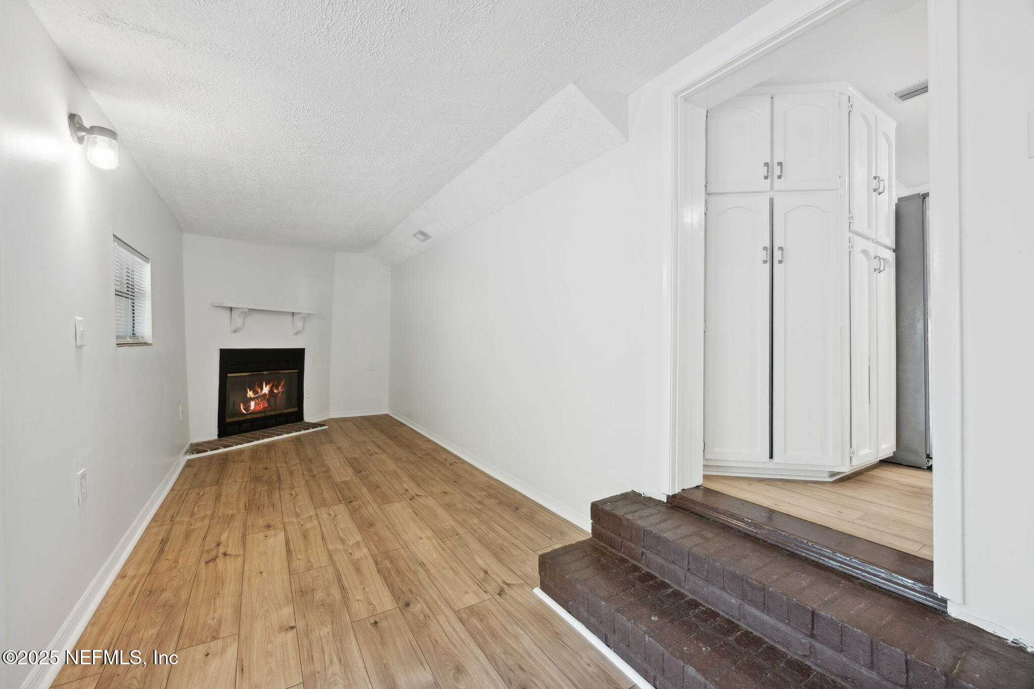 44186 Lee Drive Callahan, FL 32011 - Photo 8 of 28 a view of a livingroom with wooden floor and a fireplace