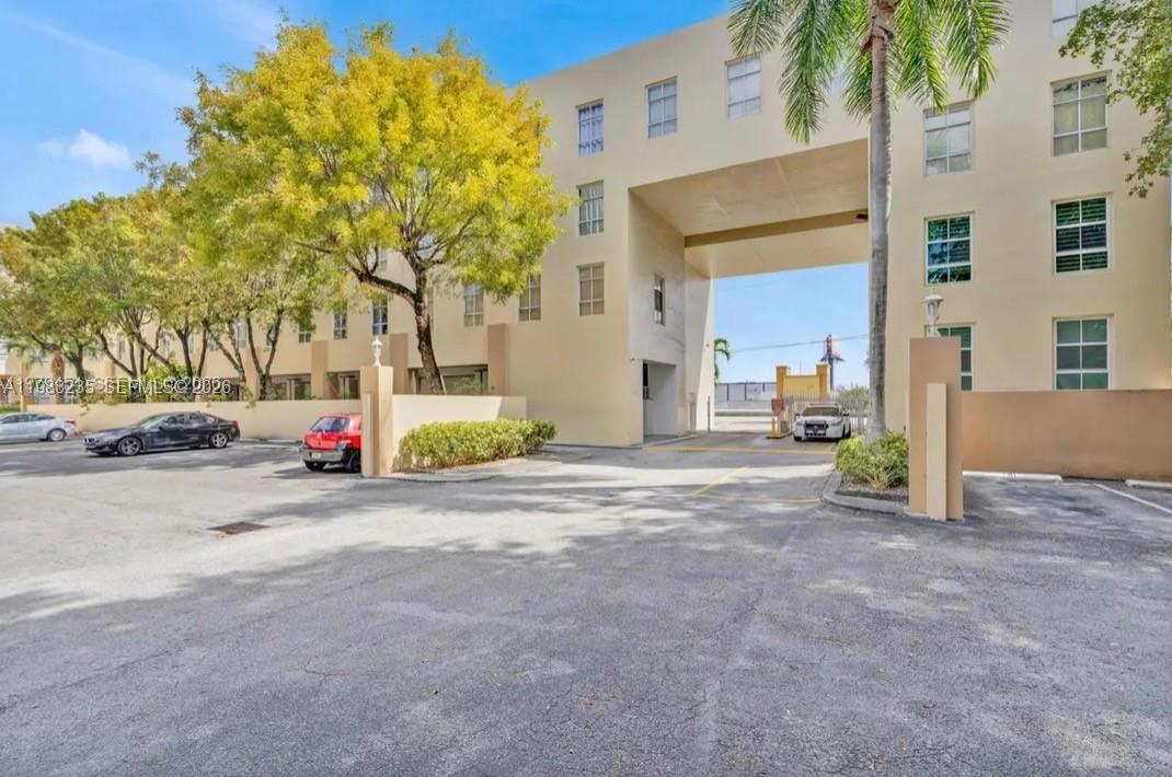 7420 West 20th Avenue, Unit 243 Hialeah, FL 33016 - Photo 4 of 9 a view of road and trees