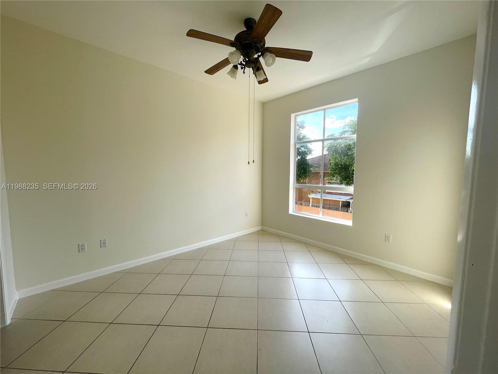 7420 West 20th Avenue, Unit 243 Hialeah, FL 33016 - Photo 6 of 9 a view of an empty room with a window