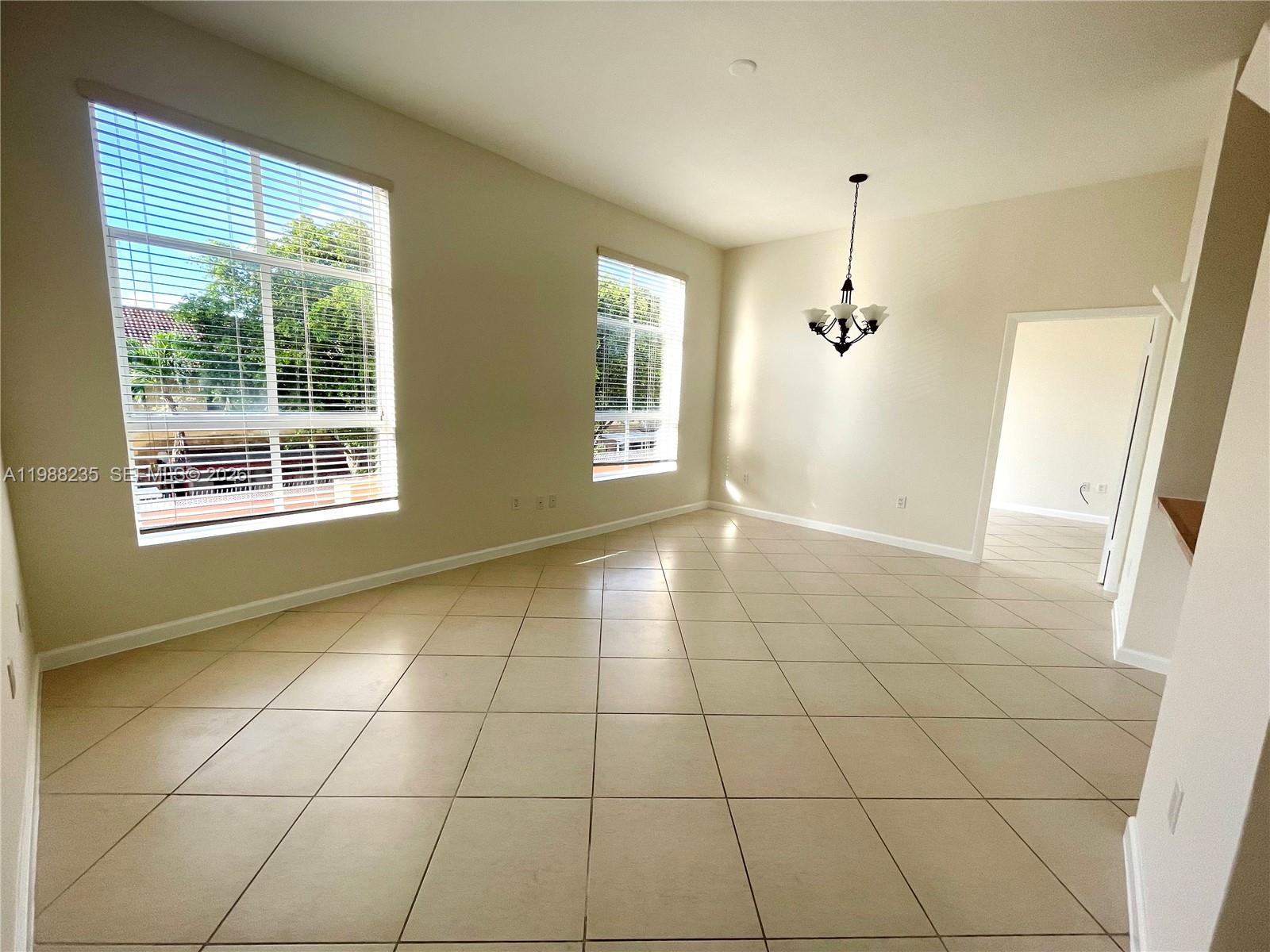 7420 West 20th Avenue, Unit 243 Hialeah, FL 33016 - Photo 7 of 9 a view of an empty room with a window