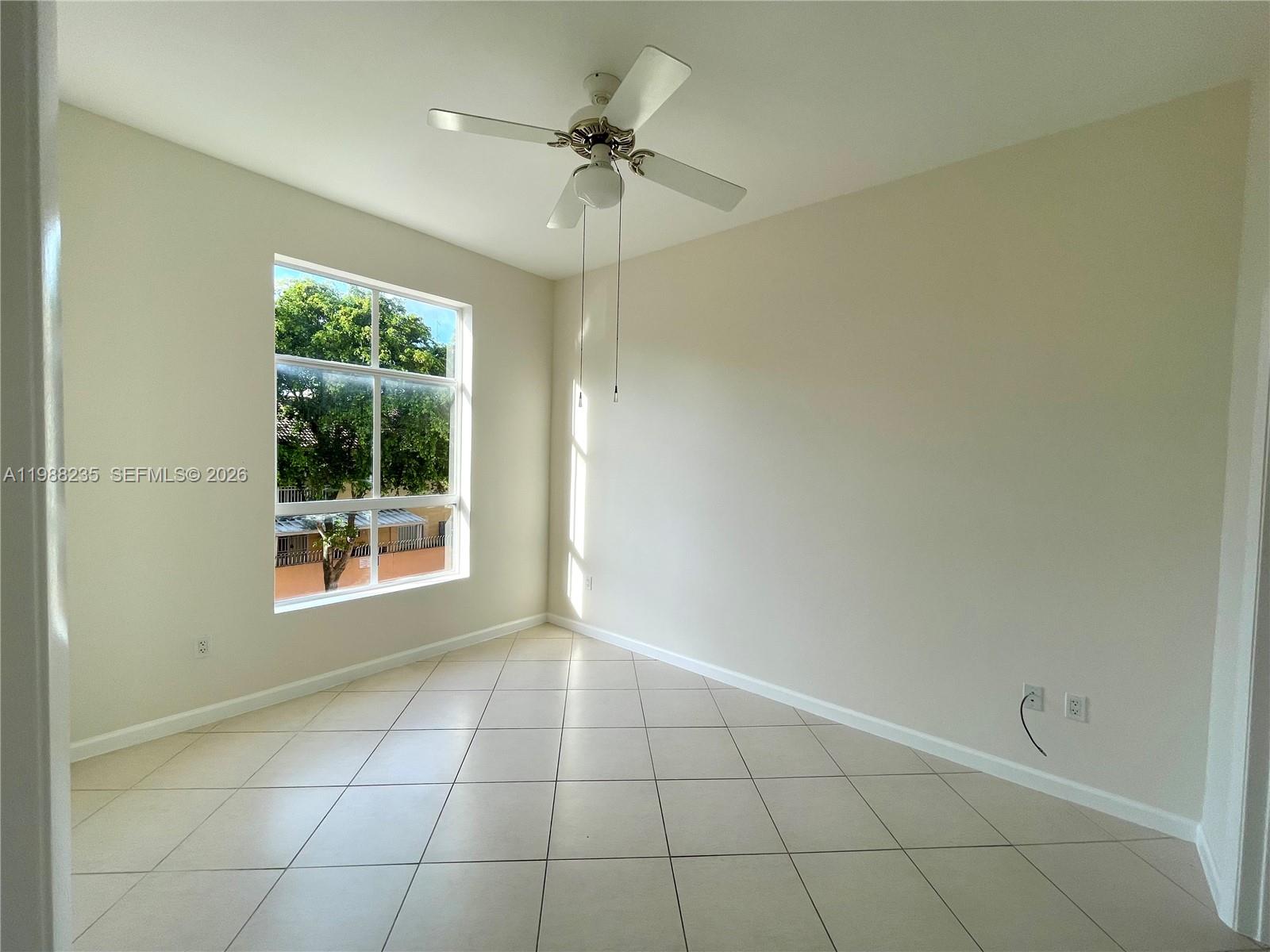 7420 West 20th Avenue, Unit 243 Hialeah, FL 33016 - Photo 8 of 9 a view of an empty room with a window
