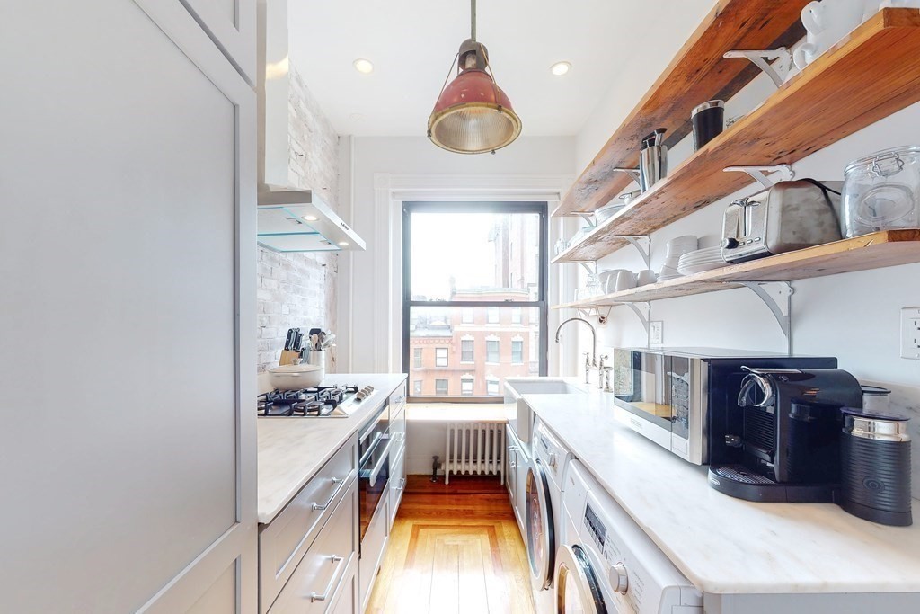 405 Marlborough Street, Unit 41 Boston, MA 02115 - Photo 12 of 32 a kitchen with stainless steel appliances granite countertop a stove a sink and a refrigerator