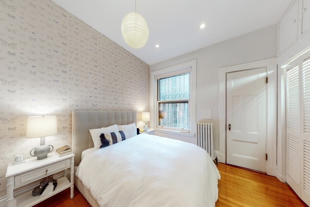 405 Marlborough Street, Unit 41 Boston, MA 02115 - Photo 16 of 32 a bedroom with a bed and wooden floor