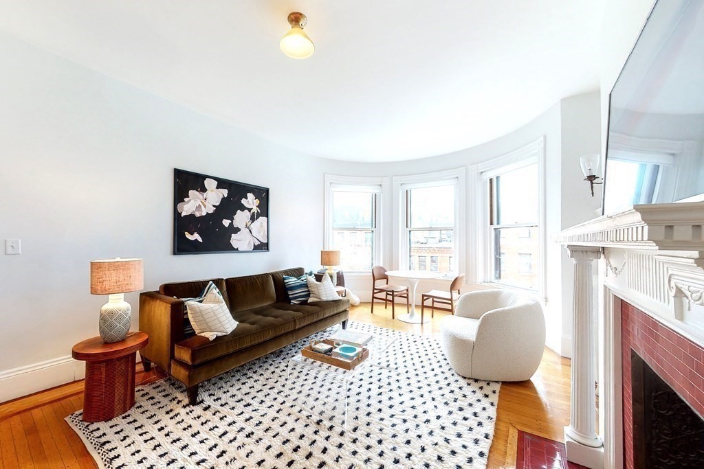 405 Marlborough Street, Unit 41 Boston, MA 02115 - Photo 4 of 32 a living room with furniture a rug and a fireplace