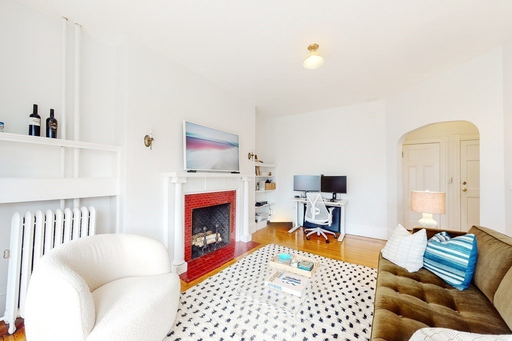 405 Marlborough Street, Unit 41 Boston, MA 02115 - Photo 7 of 32 a bedroom with furniture and a fireplace