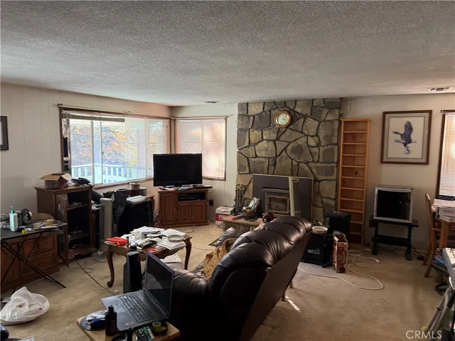 a very nice looking living room with furniture and a large window