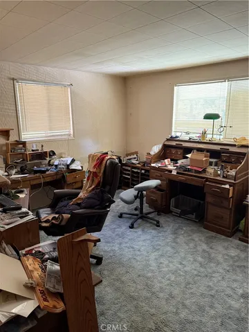 a bedroom with furniture and a window