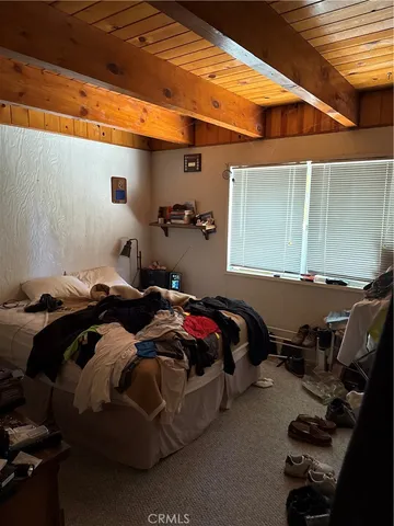 a bedroom with bed and window
