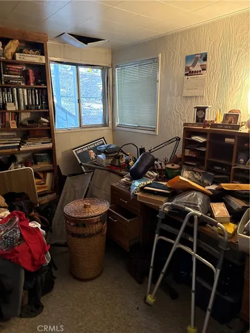 a room with wooden furniture and windows