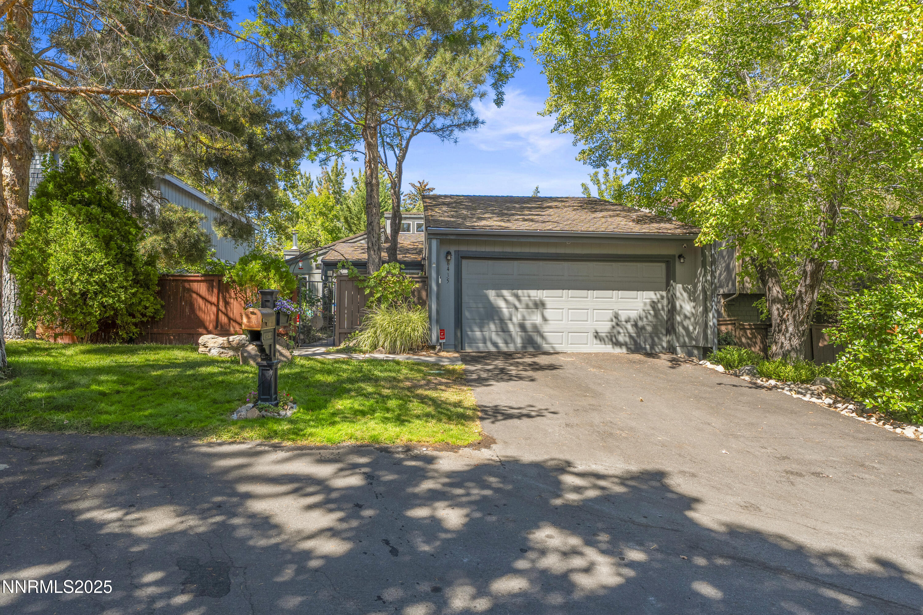 6435 Meadow Valley Lane Reno, NV 89519 - Photo 2 of 34 a front view of a house with a yard and garage