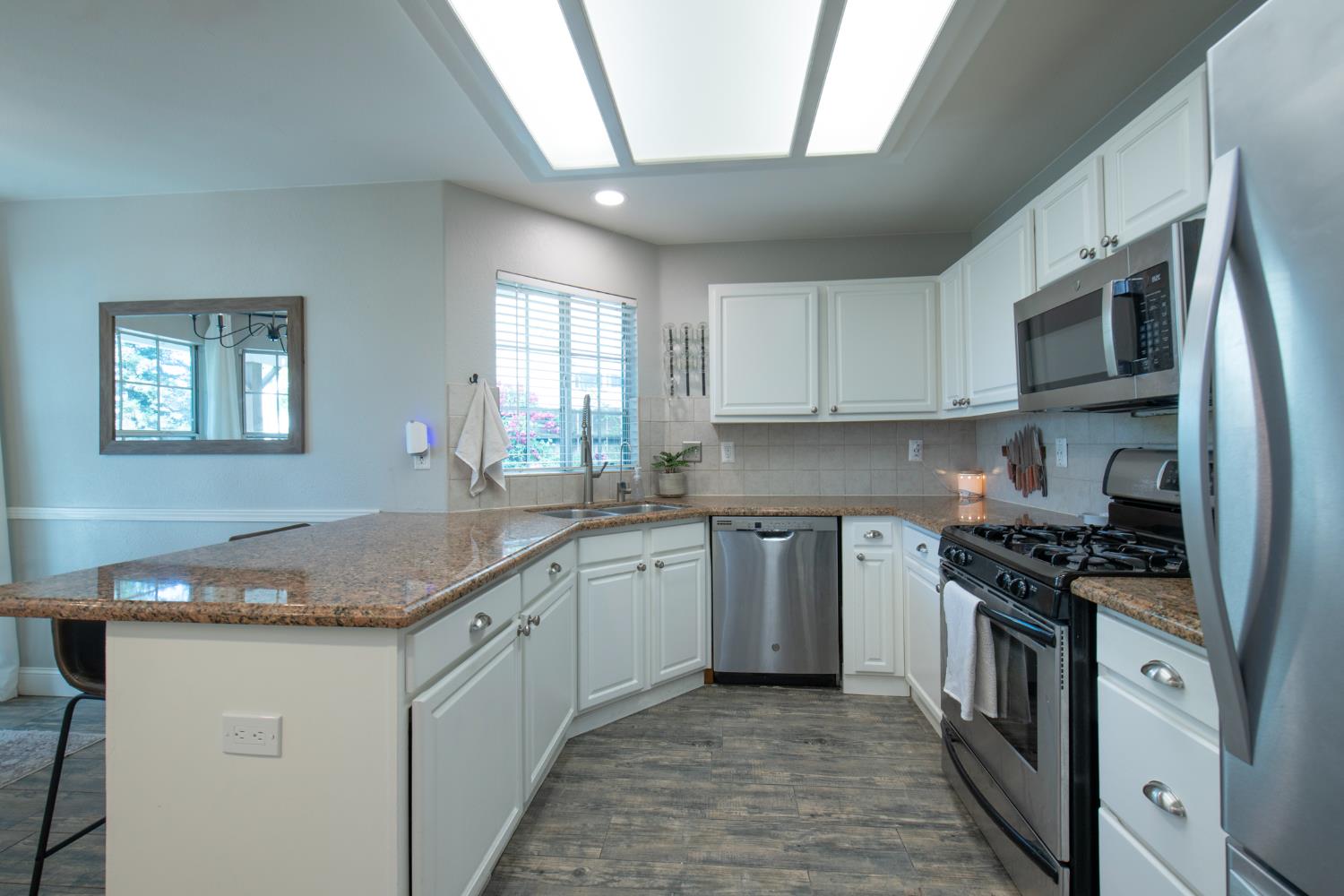 2064 Spruce Avenue Clovis, CA 93611 - Photo 9 of 50 a kitchen with stainless steel appliances granite countertop a sink stove and cabinets
