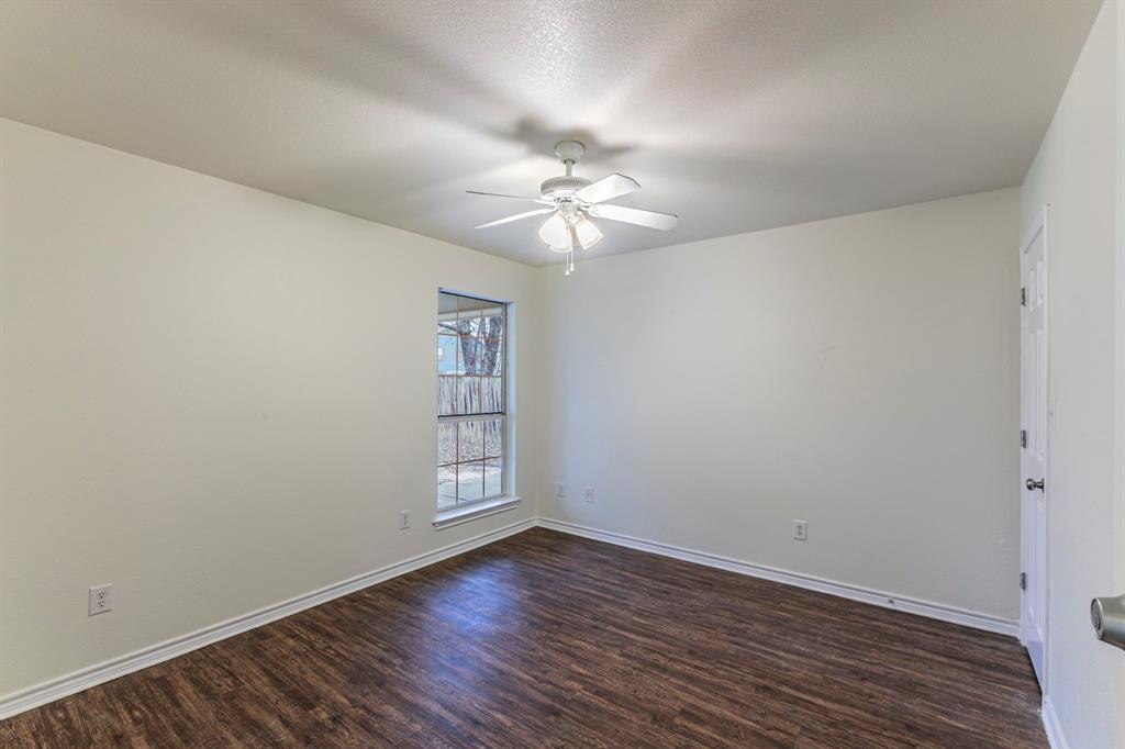 1923 South 15th Street Waco, TX 76706 - Photo 11 of 16 wooden floor in an empty room with a window