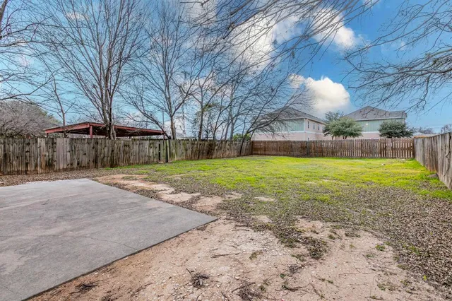 a view of a house with a yard and garage