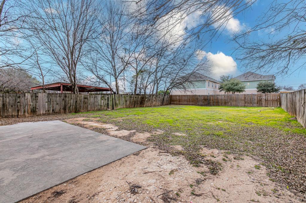 1923 South 15th Street Waco, TX 76706 - Photo 13 of 16 a view of a house with a yard and garage