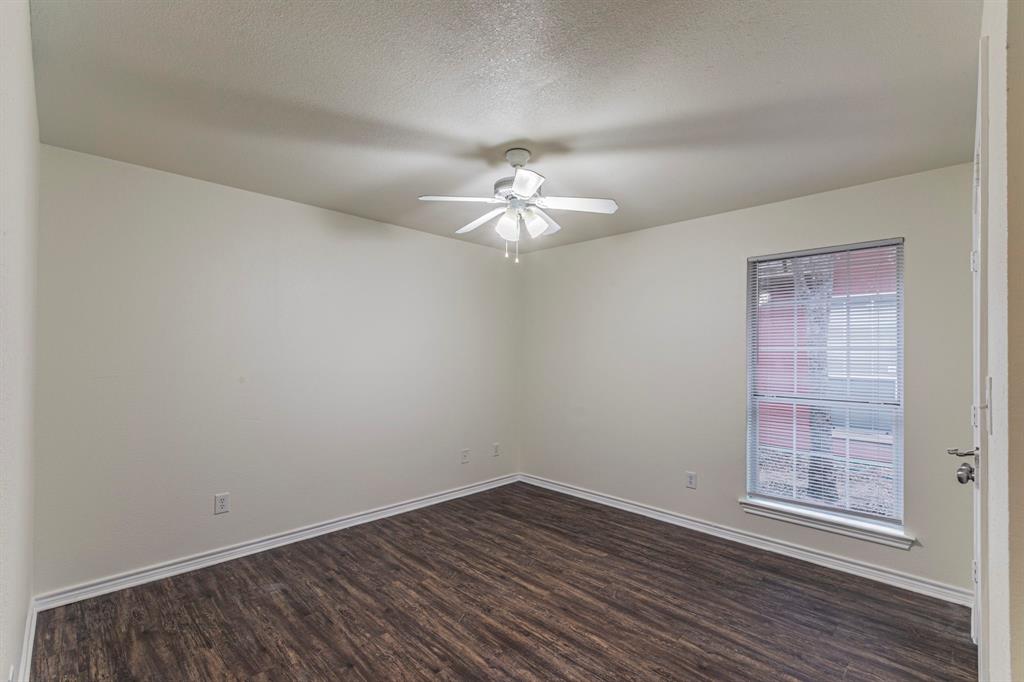 1923 South 15th Street Waco, TX 76706 - Photo 8 of 16 wooden floor in an empty room with a window
