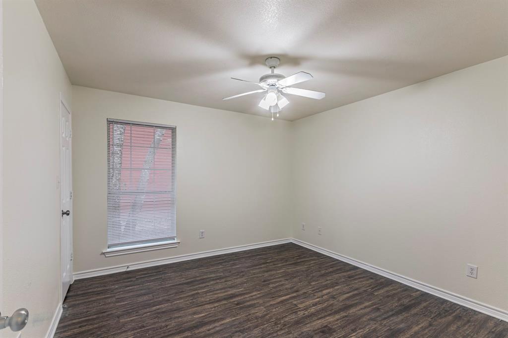 1923 South 15th Street Waco, TX 76706 - Photo 10 of 16 wooden floor in an empty room with a window