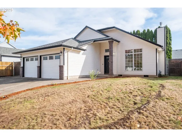 a view of a house with a yard and garage
