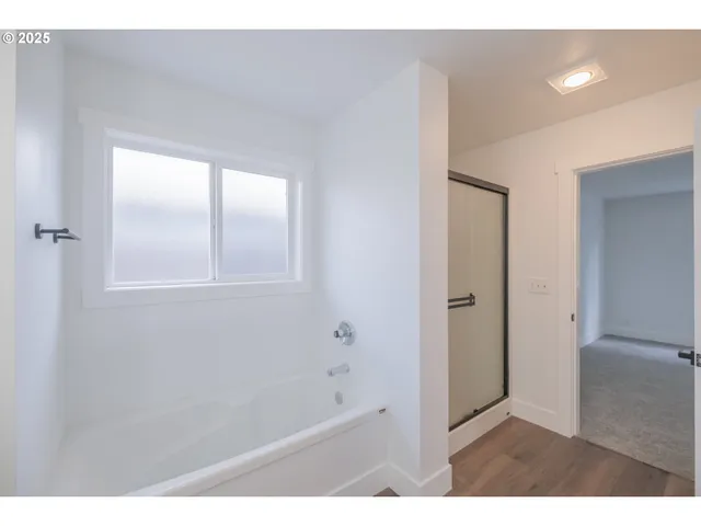 a bathroom with a bathtub and a shower