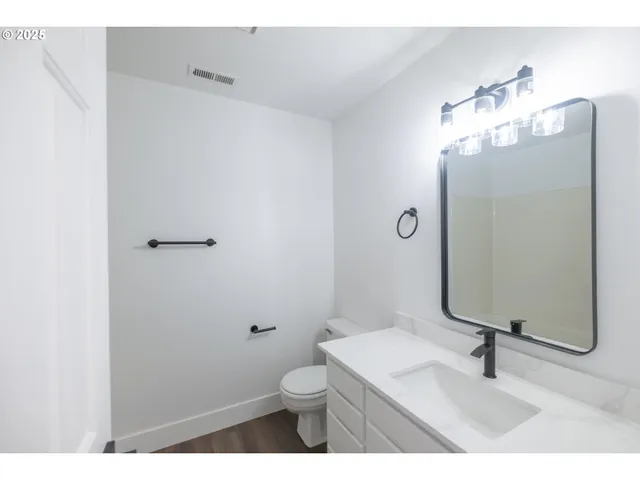 a bathroom with a sink toilet and mirror