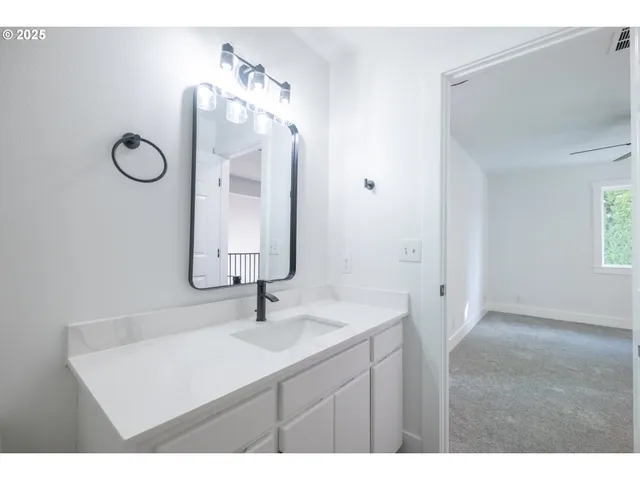 a bathroom with a sink vanity and mirror