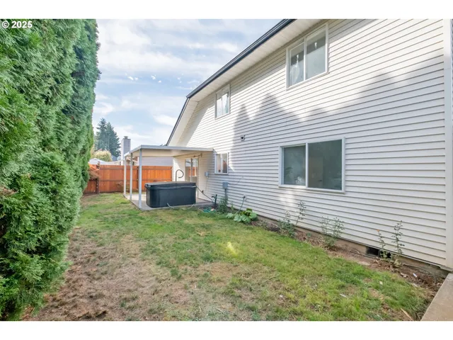 a view of a backyard with plants and a patio