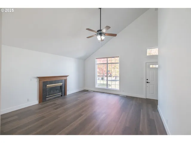 a view interior an empty room with wooden floor and a window