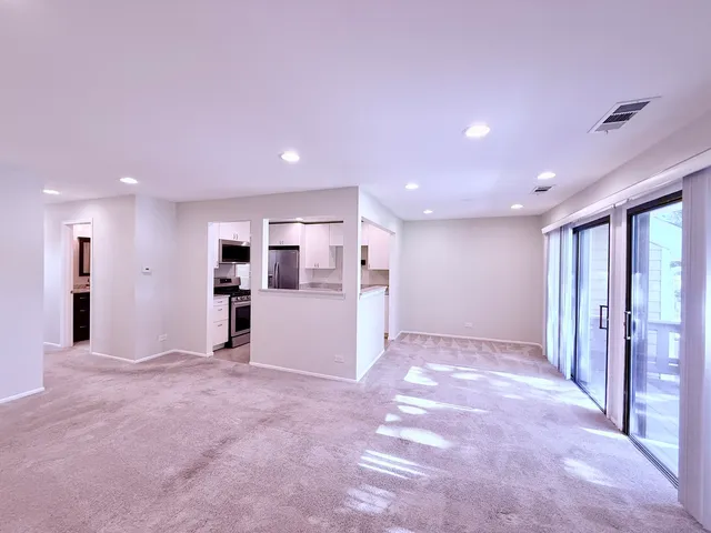 a view of a livingroom with a hall and kitchen view