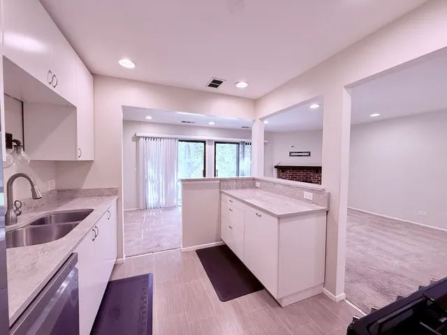 a kitchen with a sink stove and cabinets