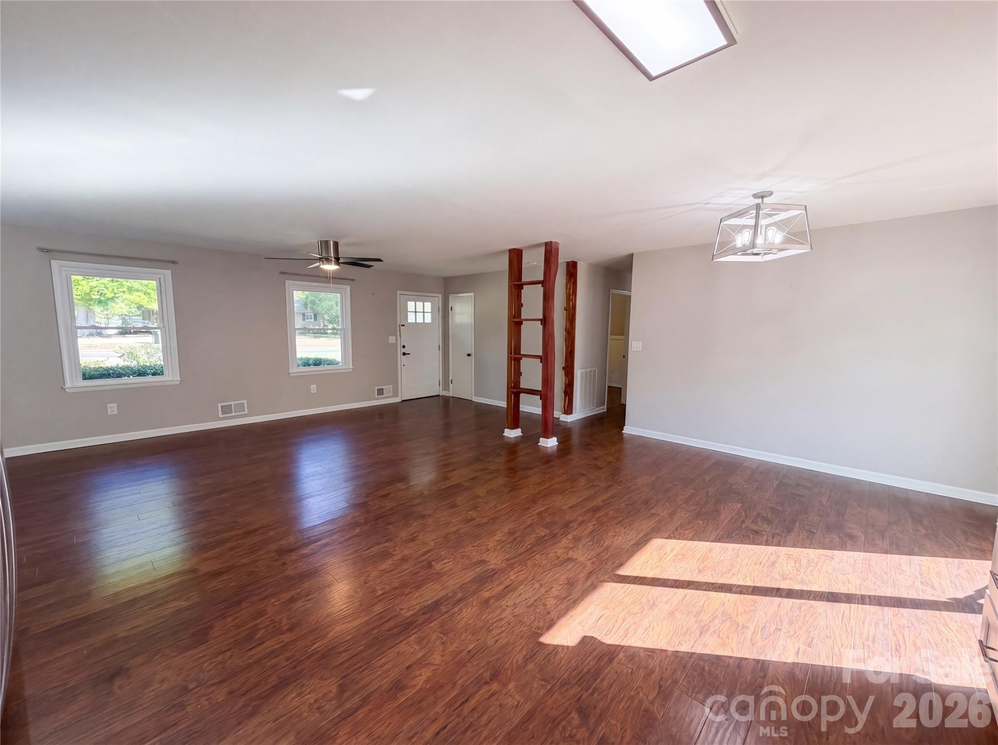 2375 Saw Road China Grove, NC 28023 - Photo 5 of 18 an empty room with wooden floor and windows